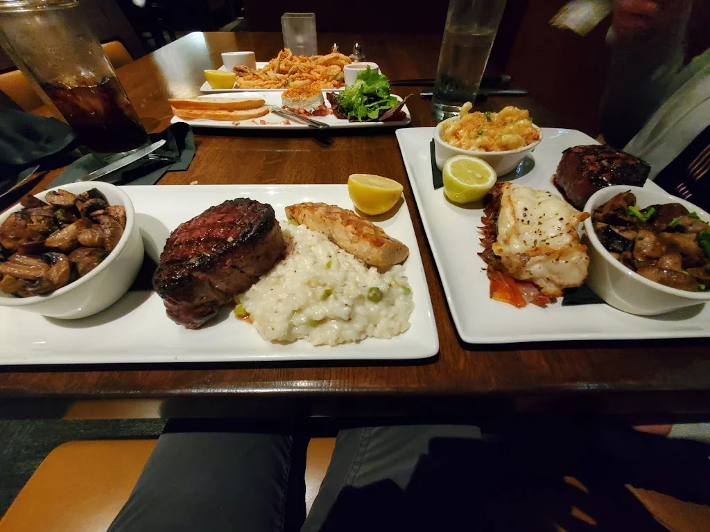 Full course steak dinner with lobster, mushrooms, mac and cheese, and fish.