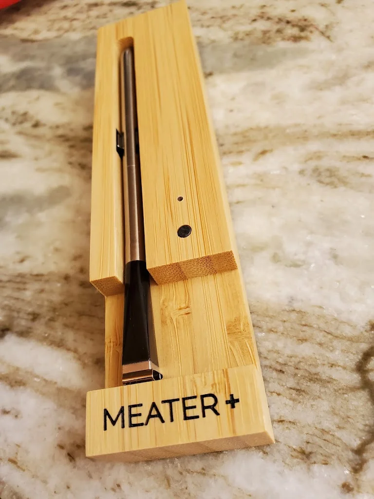 A Meater+ meat thermometer in the charging case.